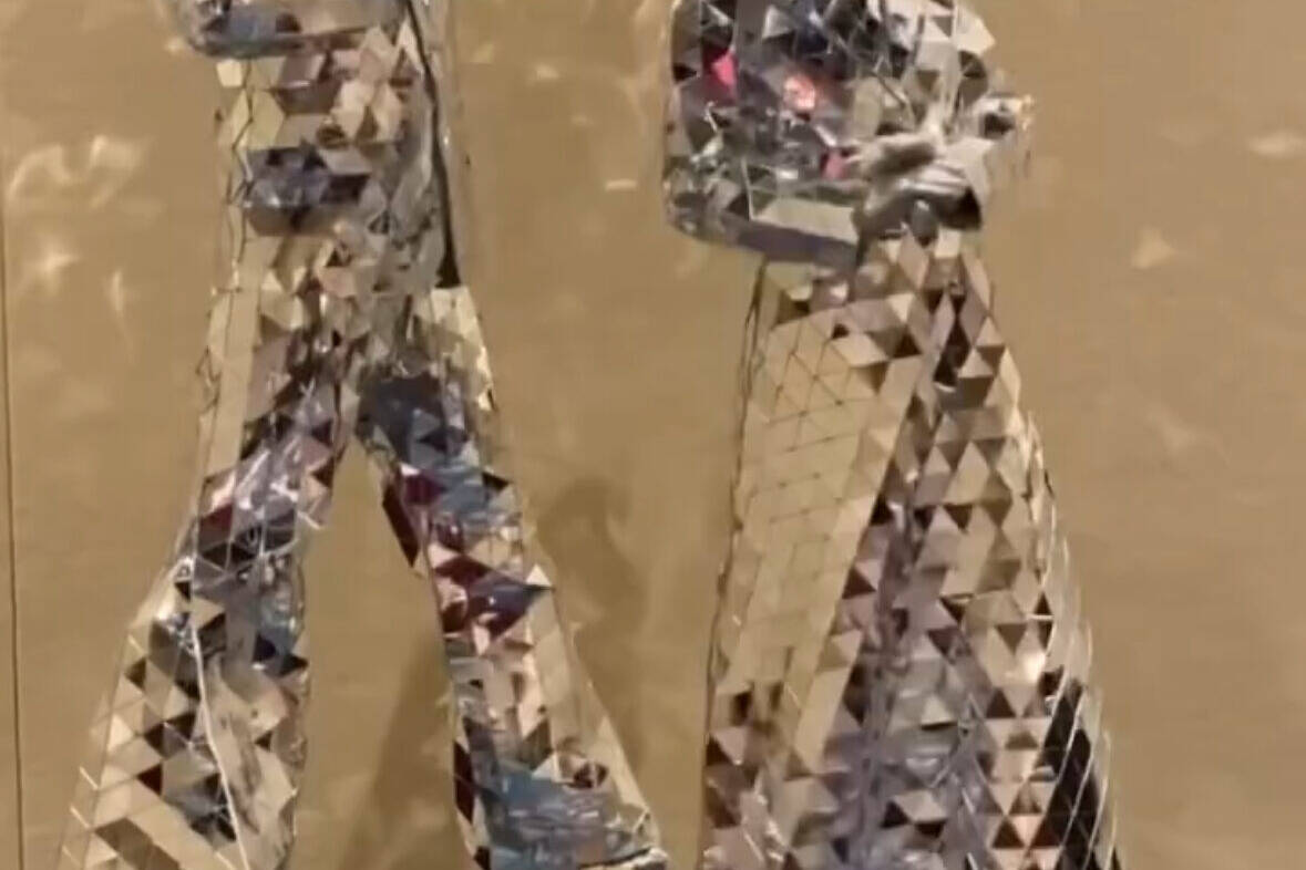 Disco themed animal head performers on stilts posing for picture