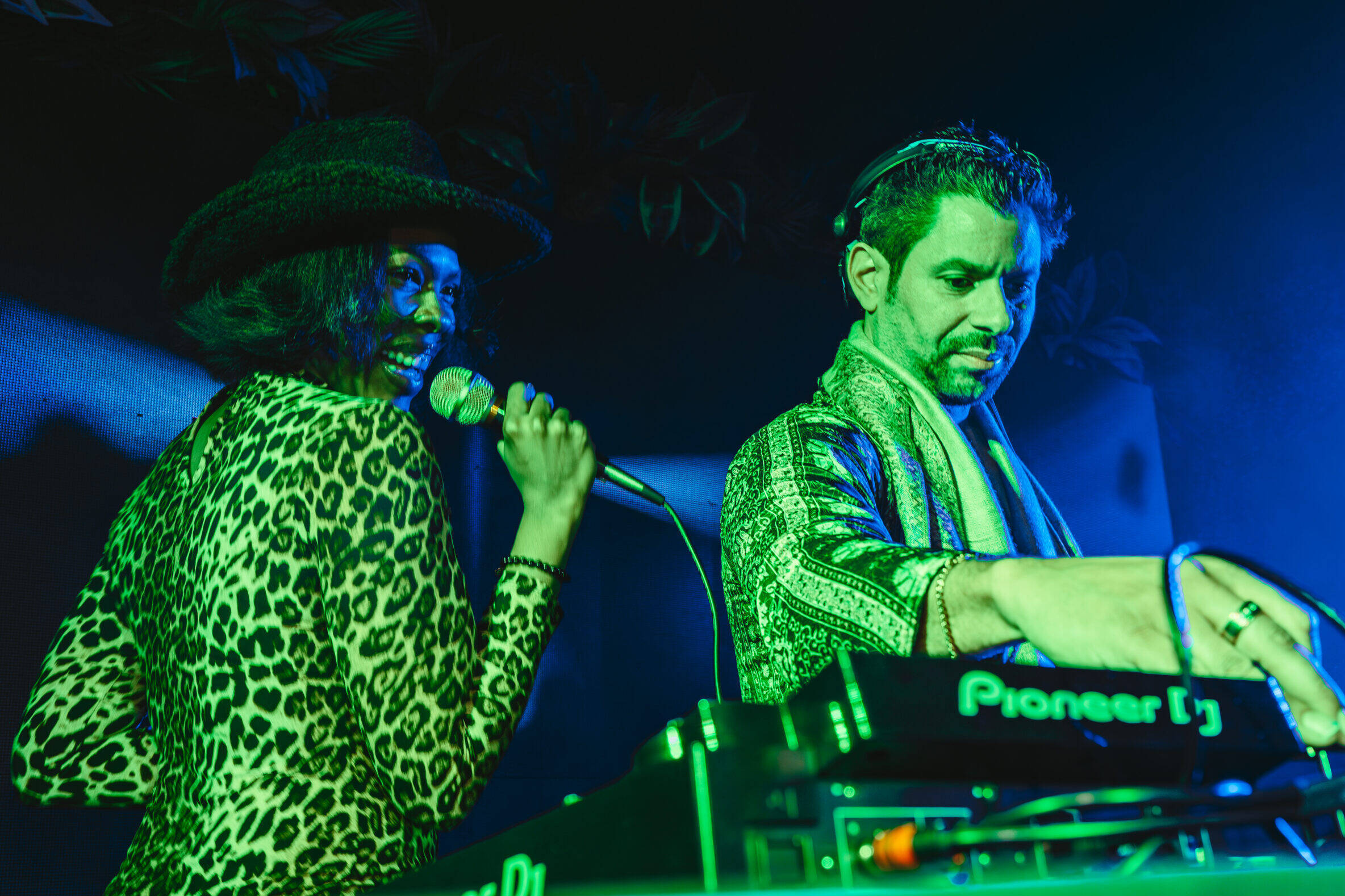singer performing live alongside a dj playing house music at las vegas event