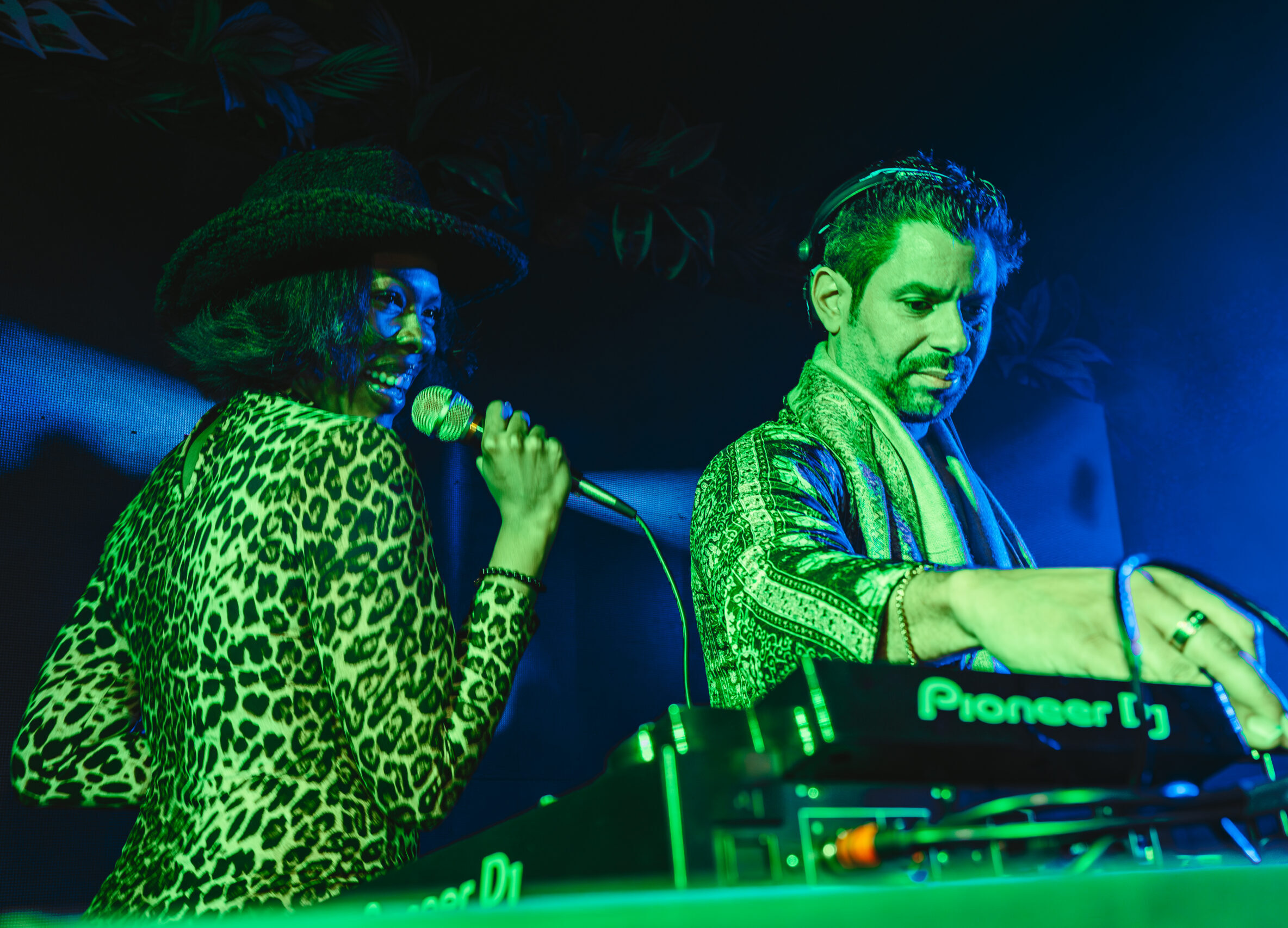 singer performing live alongside a dj playing house music at las vegas event
