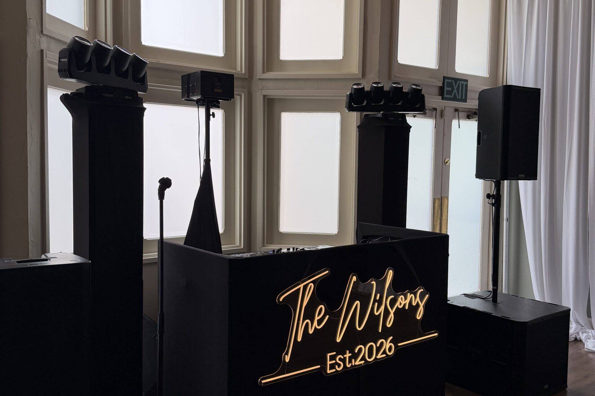 DJ booth set up with sign that says 