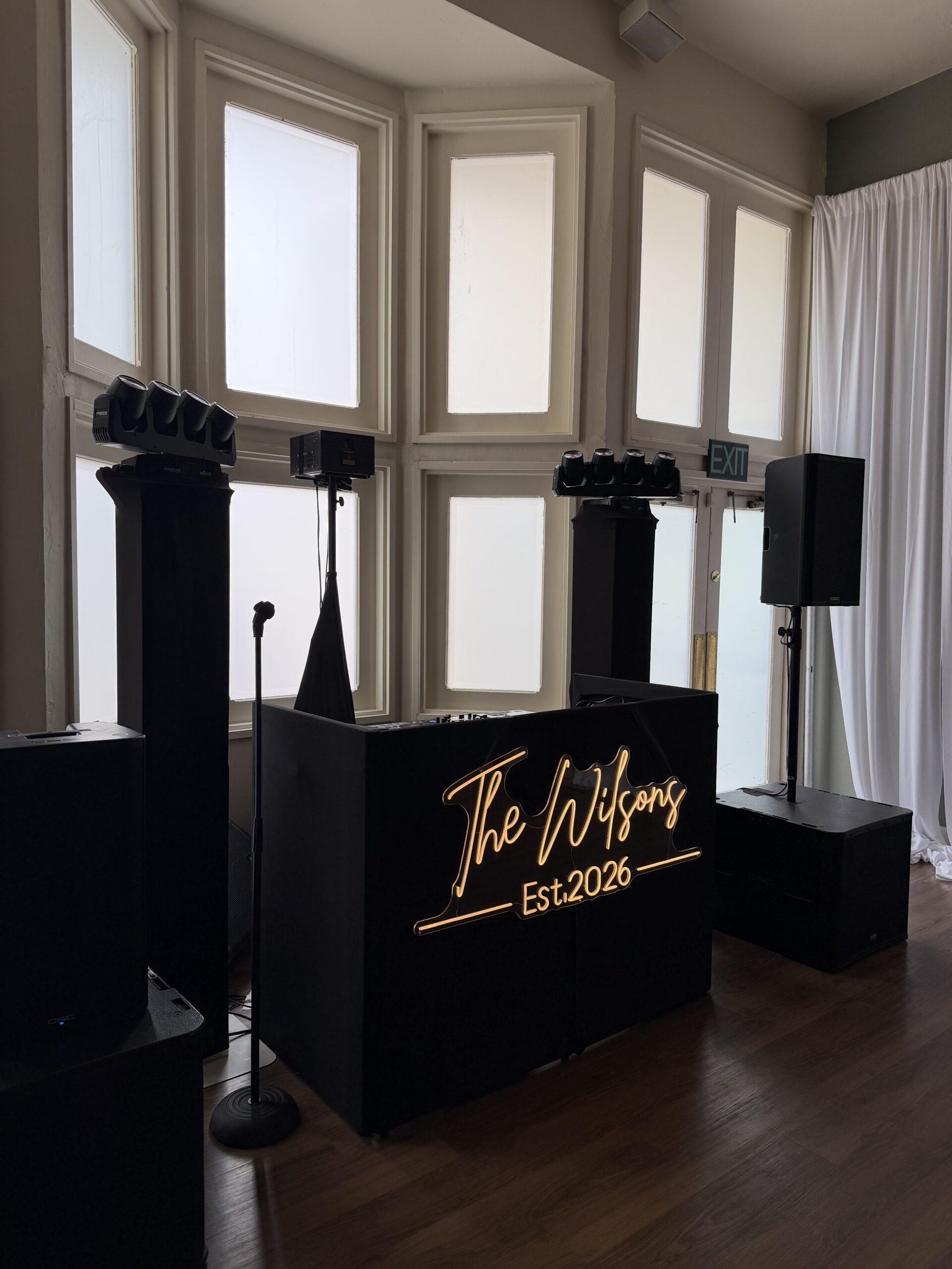DJ booth set up with sign that says 
