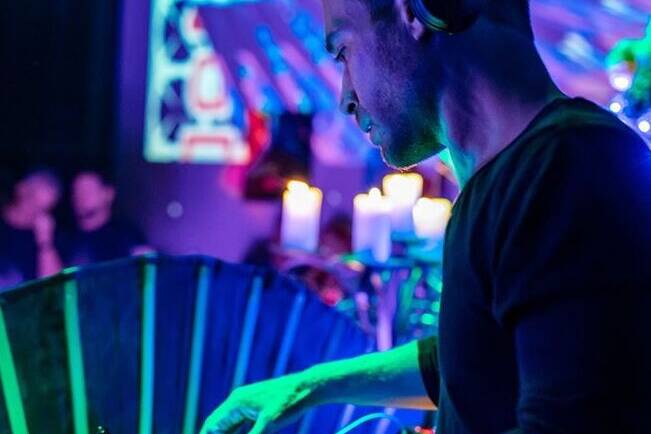 DJ performing at Las Vegas private event with ambient lights