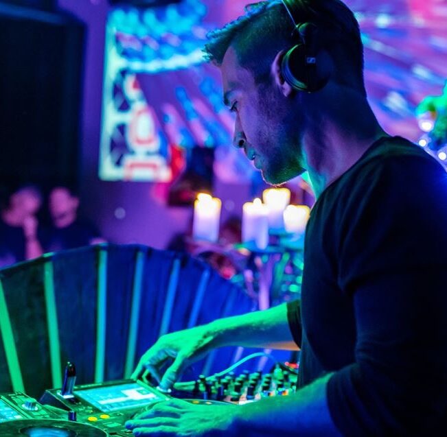 DJ performing at Las Vegas private event with ambient lights