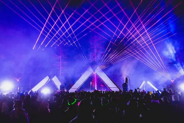 High-power laser rental in Las Vegas with beam effects over a live concert crowd