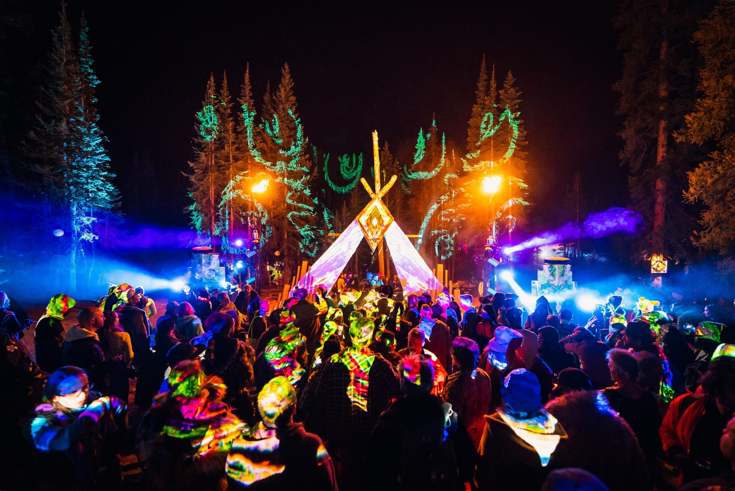 forest illuminated by colorful stage designed by Las vegas event production company Dusk Till Dawh
